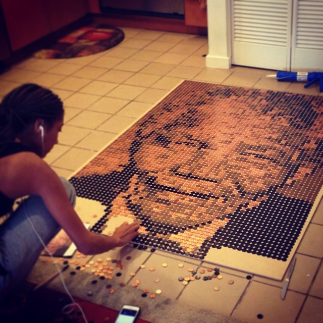 Talia making a portrait of nelson Mandela using pennies